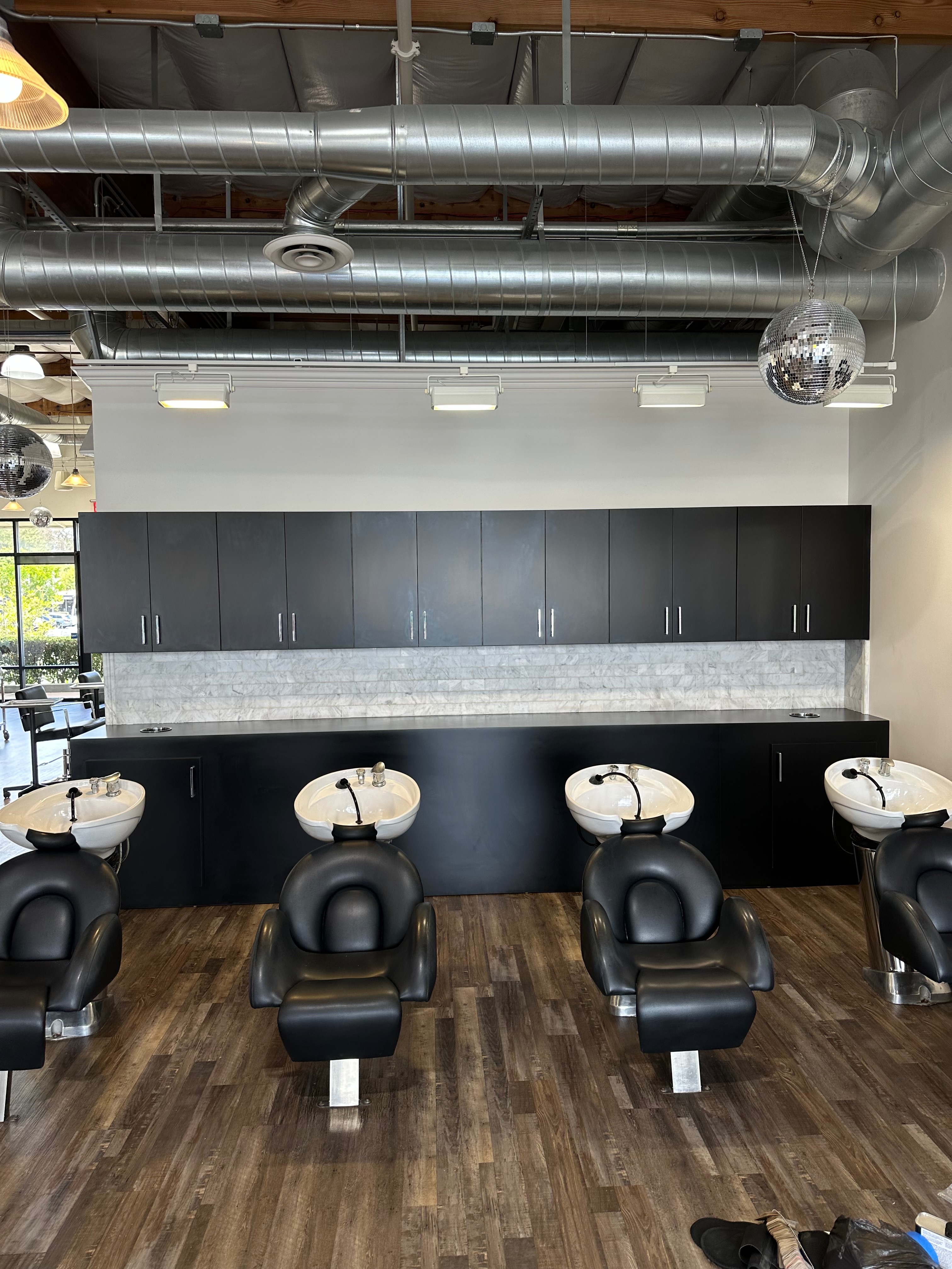 Shampoo and wash stations with black cabinetry